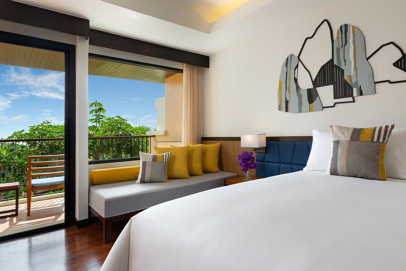 Stunning Avani Sea View Room boasting warm wood paneling, contemporary decor, and a scenic private balcony